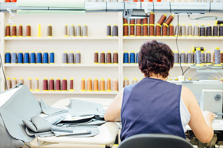 Woman works in a upholstery factory