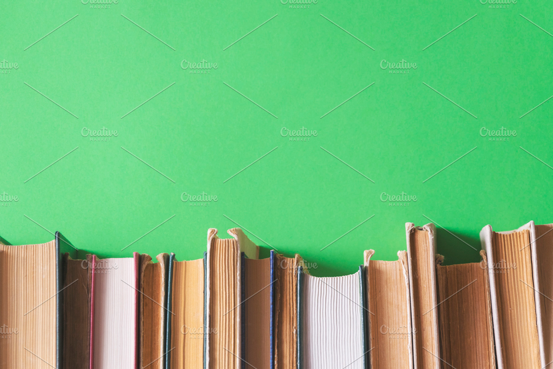 Old books on a green background, a School & Education Photo by Ti-Di