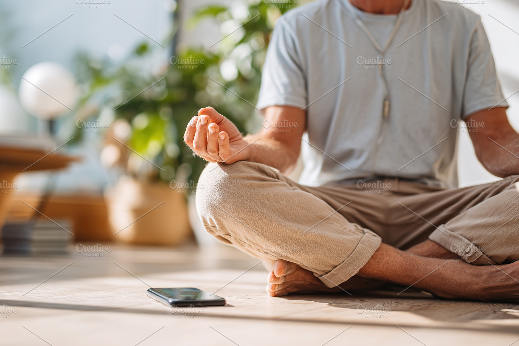 Meditation practice in a bright indoor space with smartphone nearby, a Photo by AlyaAnd