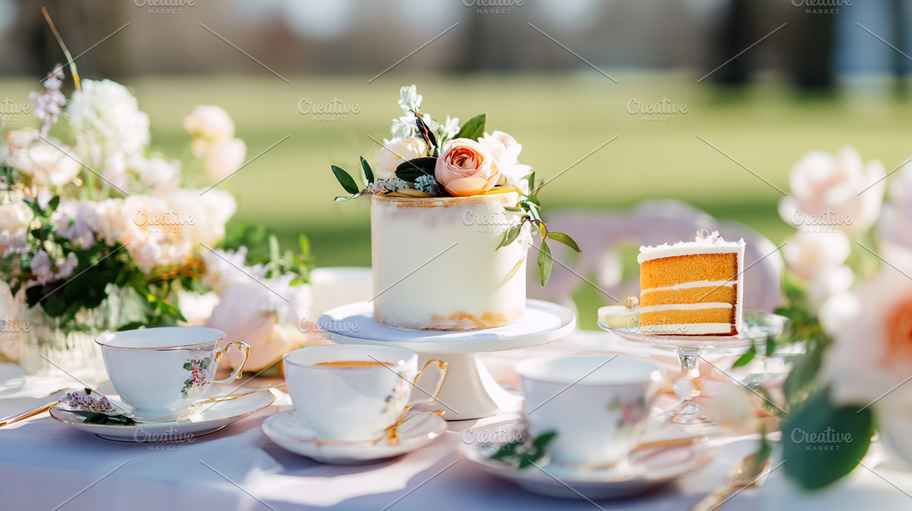 Outdoor tea party setting with elegant cake, sliced dessert, tea, a Photo by Studio ANNA