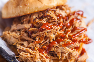 Pulled pork sandwich close up featuring appetite, barbeque, and bread