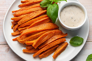 Sweet potato fries with dipping sauce and fresh basil, a Food & Drink Photo by Olena Rudo