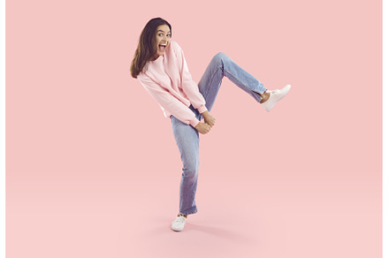 Cheerful young woman dancing