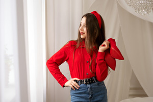 Teen girl holding red high heels, a Person Photo by Elena Vagengeim