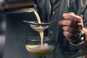 Professional bartender preparing a drink, a Photo by Grafvision photography