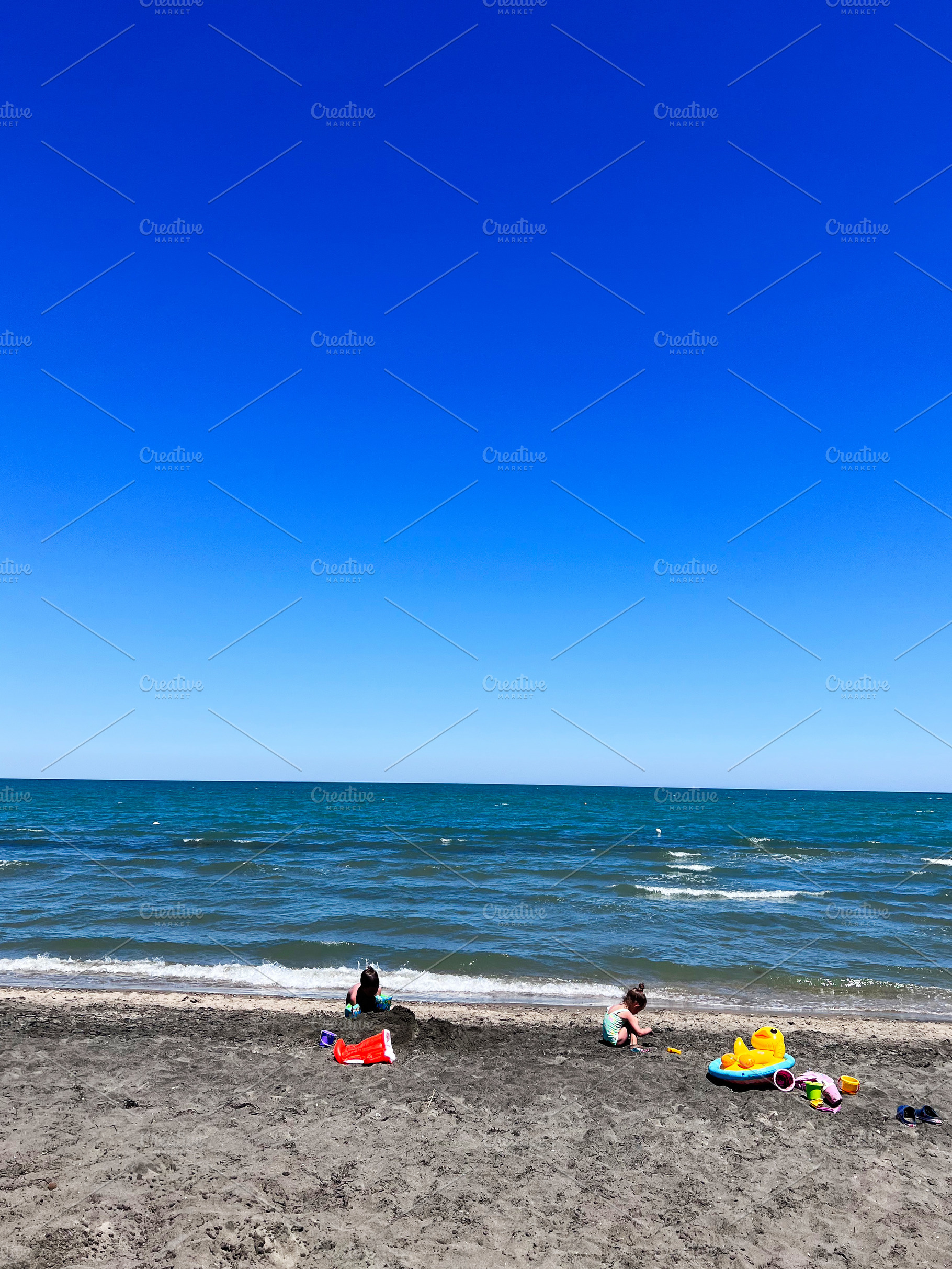 Children playing with toys on a sandy beach in summer. Manfredonia, Italy., a Photo by AS photostudio