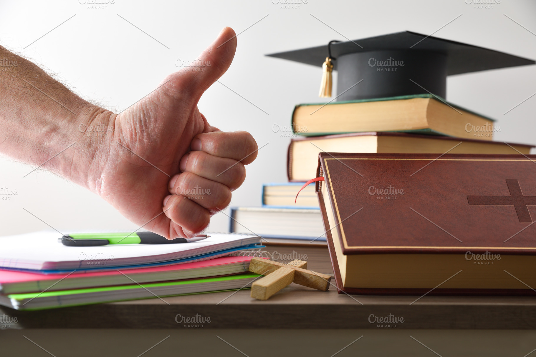 Religious educational material and hand with OK gesture, a School & Education Photo by Davizro's Market