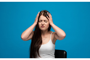 Young woman is having a headache, a Person Photo by volodymyrshtun13795