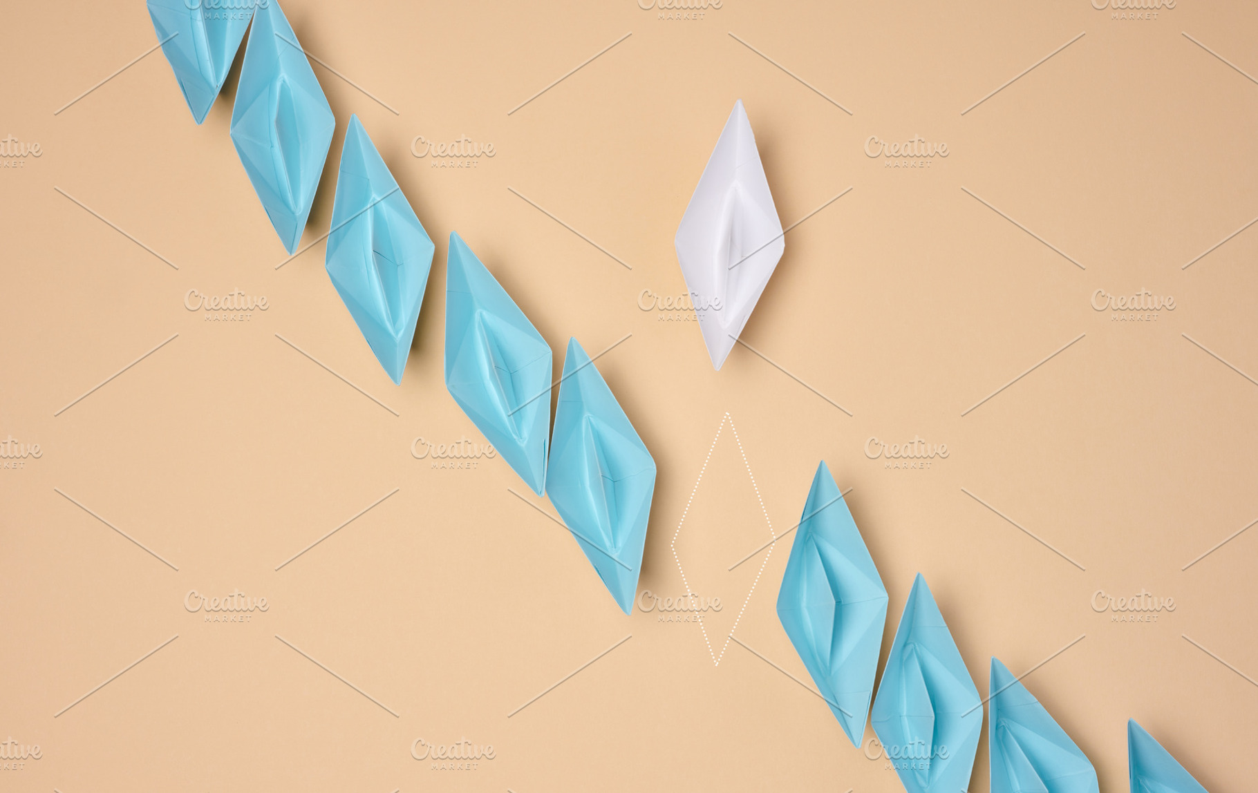 A line of blue origami paper boats with one white and the outlin, a Business Photo by ndanko