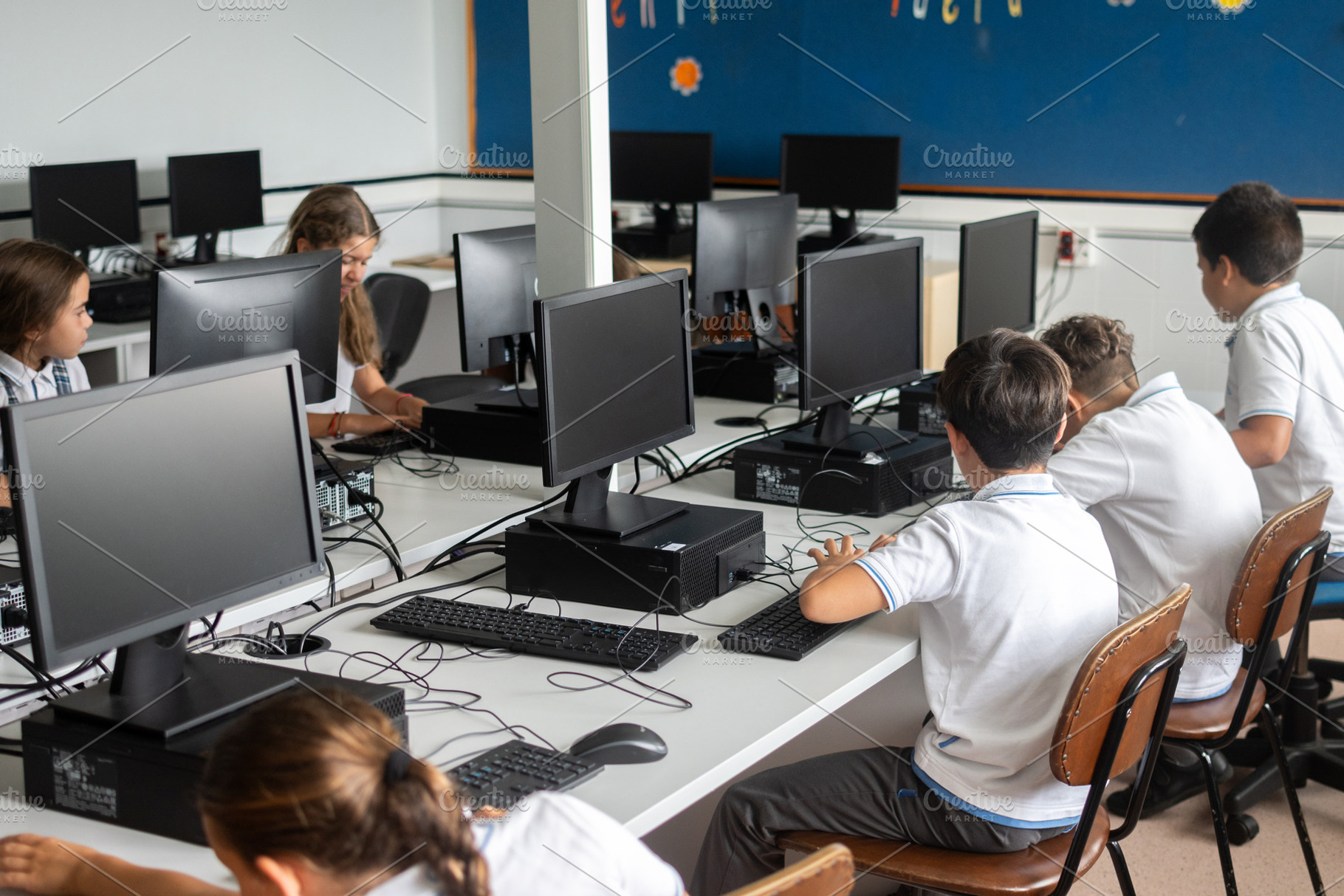 Elementary school students using desktop computers in computer lab, a School & Education Photo by etorres69