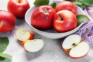 Red apples in bowl with slices on table, a Food & Drink Photo by Olena Rudo