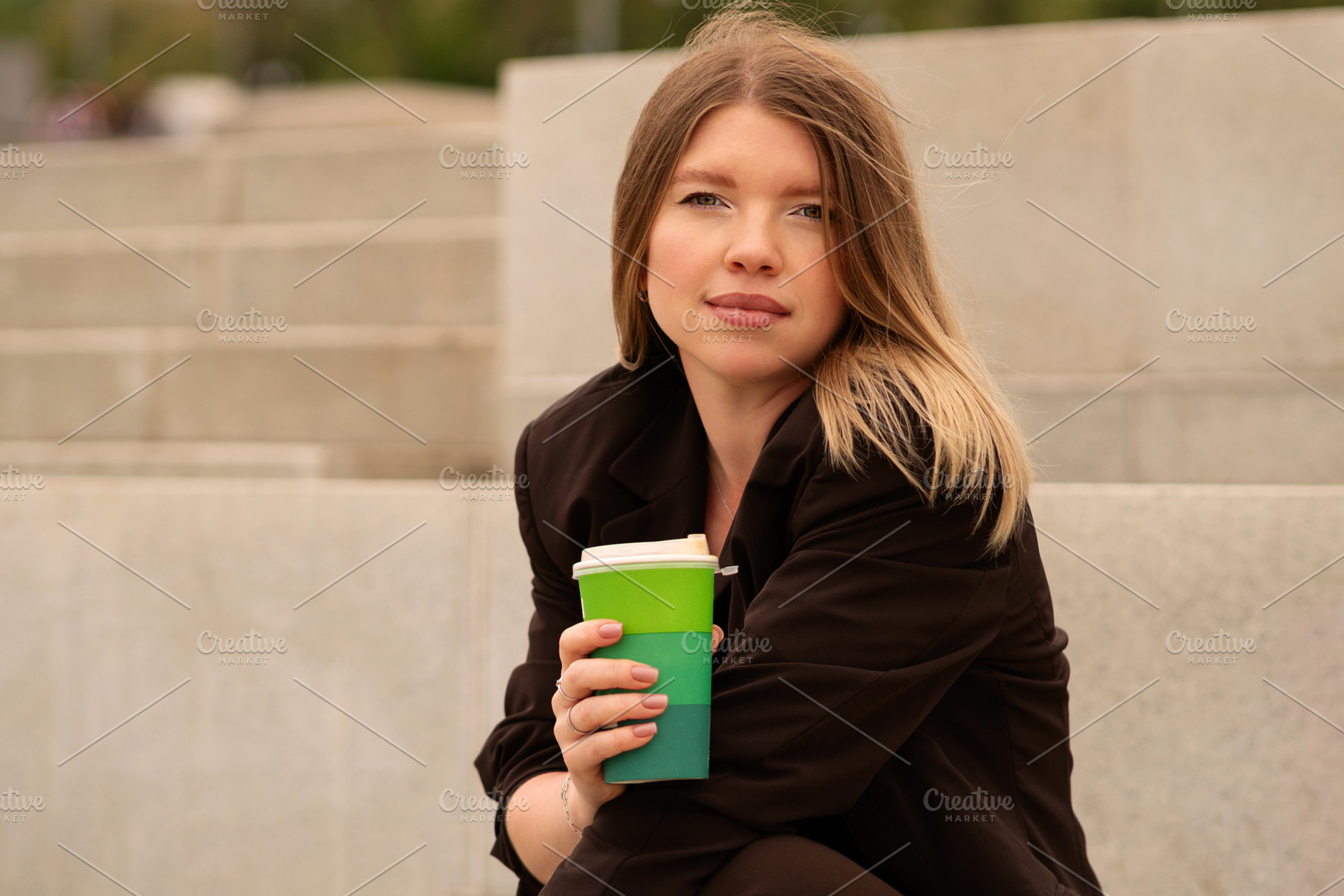 Young woman holding coffee cup, a Person Photo by Elena Vagengeim