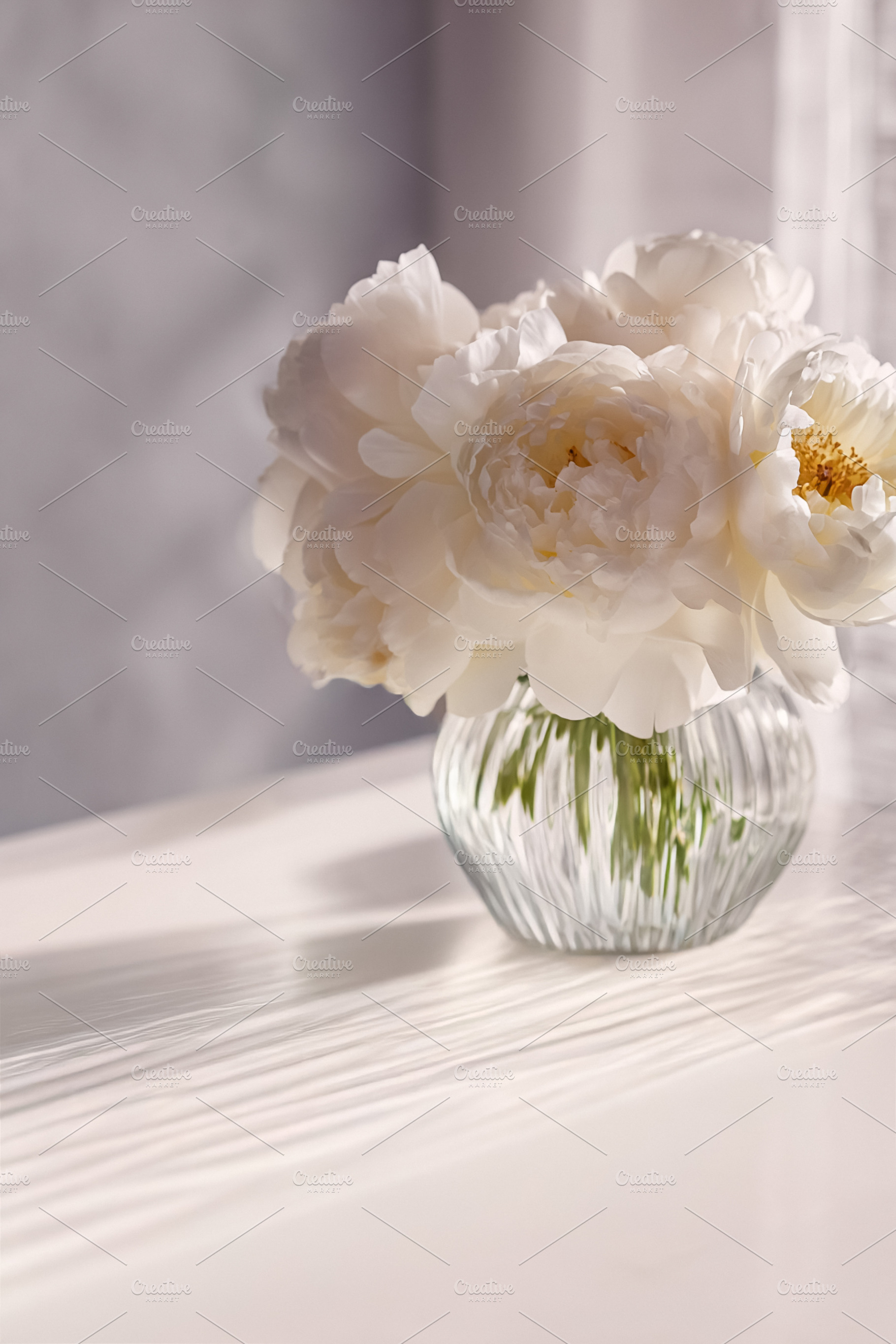White peonies blooming in a ribbed glass vase on a sunlit table,, a Photo by Studio ANNA
