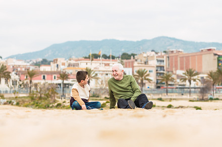 Little boy and his grandfather spending time on the beach, a Photo by Cosca