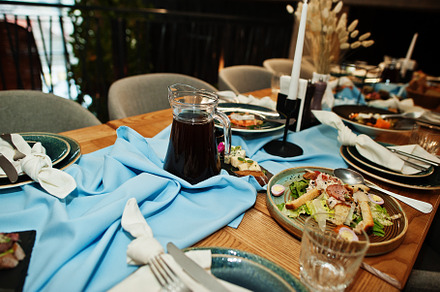 Beautifully laid tables with food, glasses and appliances in res, a Food & Drink Photo by AS photostudio