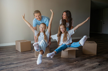 Happy family with two daughters have fun in their new home. Parent with kids en, a Person Photo by travnikovstudio