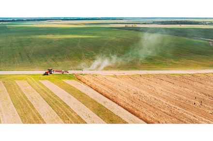 Aerial View. Tractor Plowing Field, an Industrial Photo by Our Amazing World