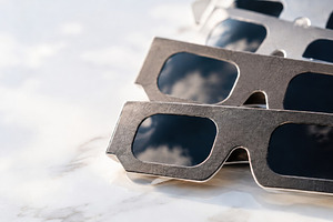 Solar eclipse viewing glasses on whi, a Photo by Dvoevnore photos