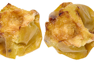 Two whole baked green apples with soft, wrinkled skin. Isolated, a Food & Drink Photo by ndanko