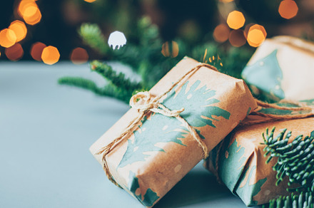Gift boxes and paper ornate on wooden table. Christmas background with copy spa