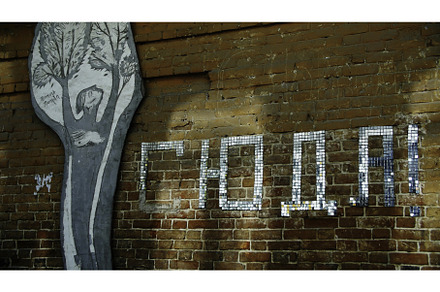 Red brick wall with letters and art, a Background Photo by Media Whale Stock