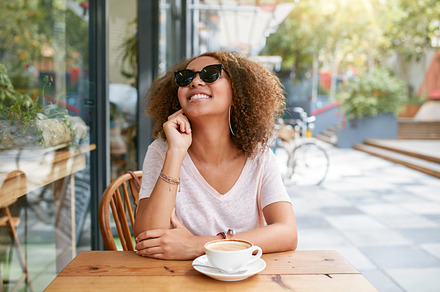 Young woman sitting at sidewalk cafe, a Person Photo by Jacob Lund