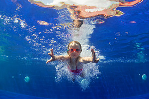 Funny child dive in swimming pool featuring swimming, pool, and child