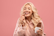 Young caucasian lady eating chocolate, enjoying yummy dessert with closed eyes,, a Photo by Prostock-Studio (Thumbnail 1 of 2)