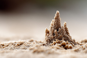 Sandcastle rising from soft beach, a Nature Photo by MistyDay