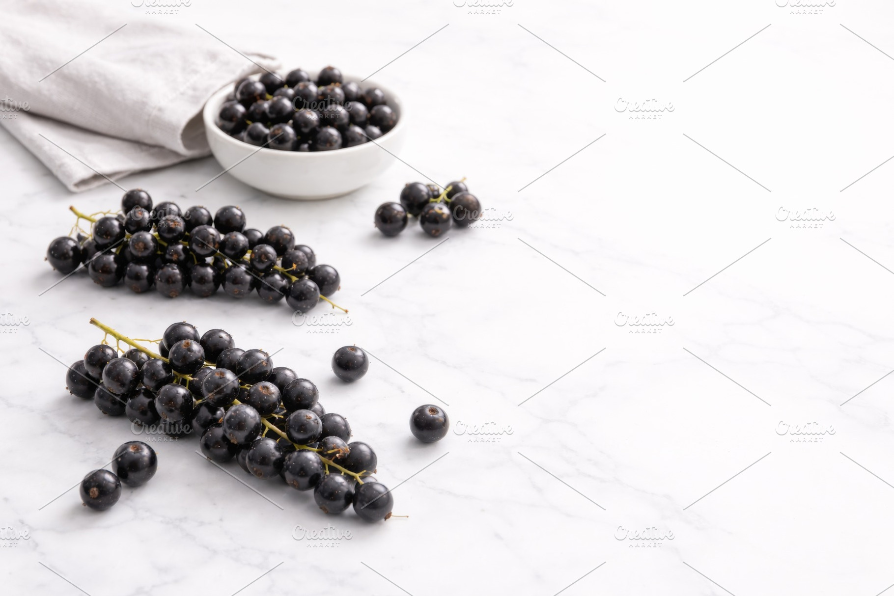 Black currant berries on white marbl, a Photo by Dvoevnore photos