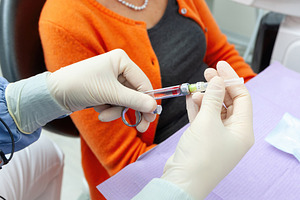 Dentist preparing anesthetic injection for patient in clinic, a Health & Medical Photo by Antonio Gravante Market