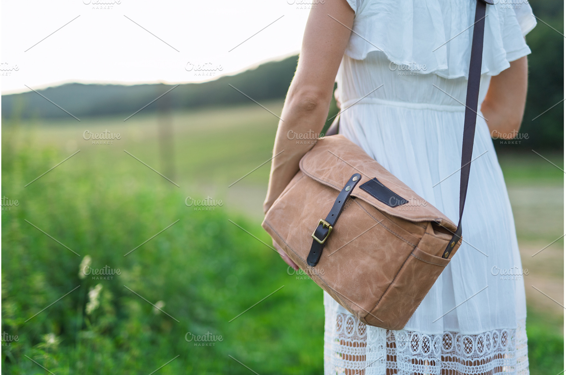 Woman fastening leather strap on, a Person Photo by HalfPoint