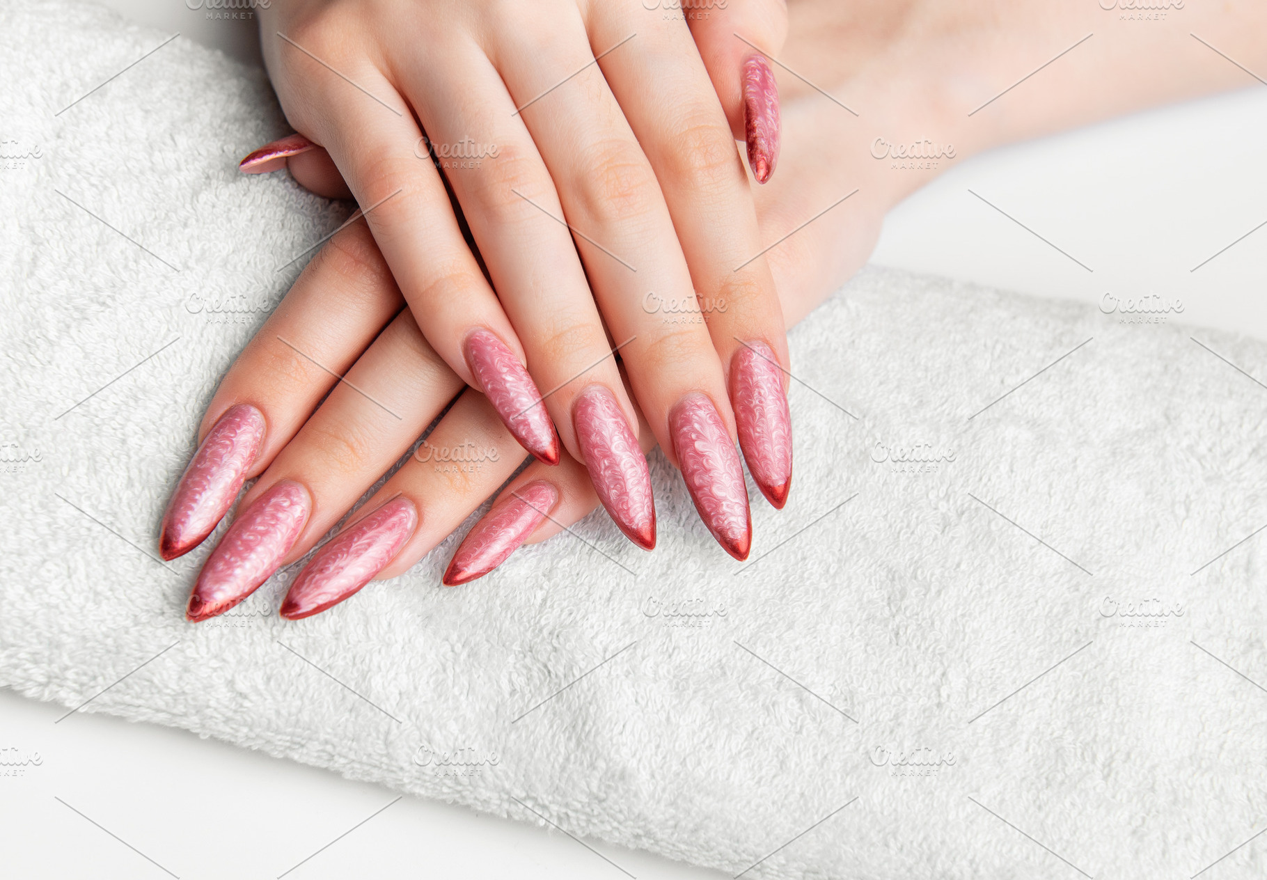 Woman's hands resting on towel with pink stiletto nails, a Beauty & Fashion Photo by Olena Rudo
