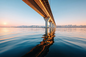 Serene bridge reflection at sunrise, an Architecture Photo by AlyaAnd