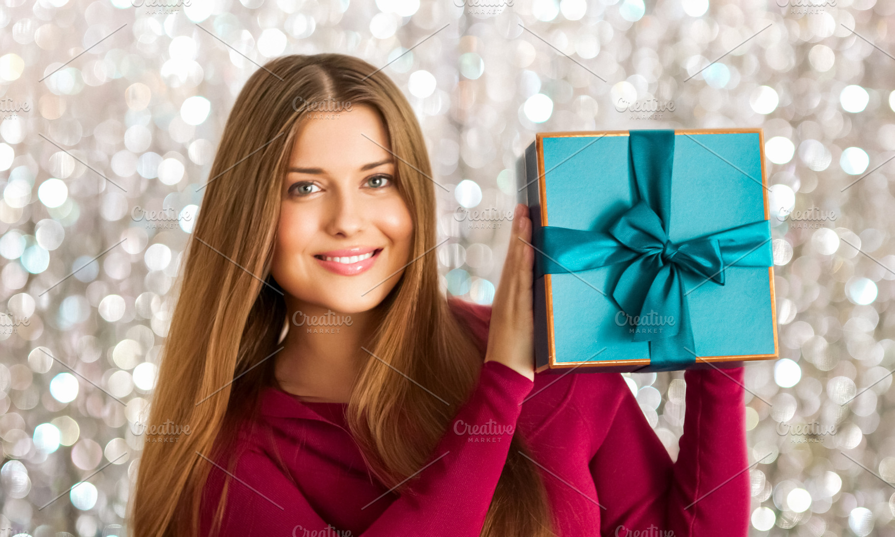 Happy woman holding a beautiful turquoise gift box, celebrating, a Person Photo by Studio ANNA