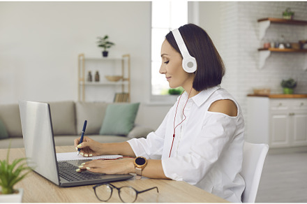 Woman sitting in front of laptop, a Person Photo by StudioRomantic