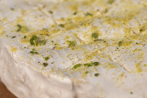white soft cheese in salt and spices and small red round tomatoes on the table, a Photo by rsoollAI