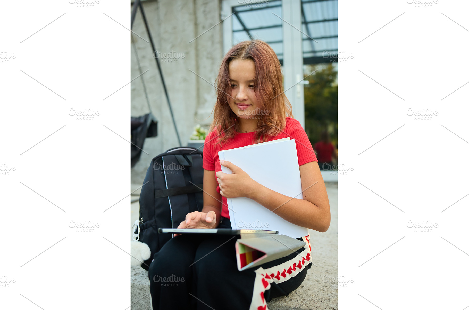School girl uses tablet while, a School & Education Photo by IlliaBondarPhotography