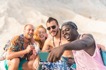 four friends having fun and posing for a selfie, a Holiday Photo by Iván Moreno STOCK PHOTO