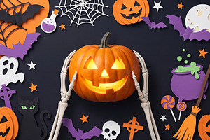 skeleton holding Halloween pumpkin