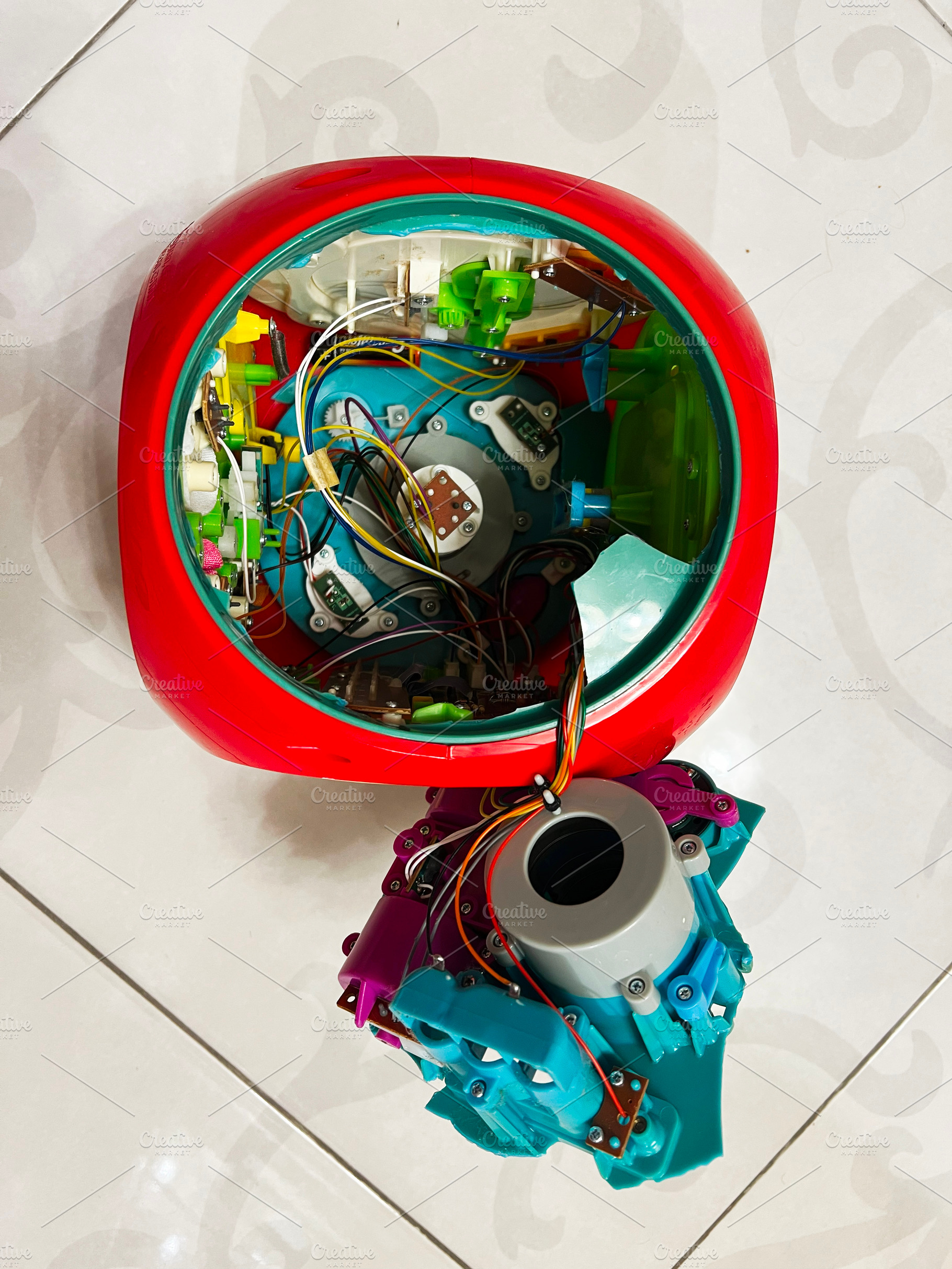 Interior view of a disassembled robotic device with colorful wiring and compone, a Photo by AS photostudio