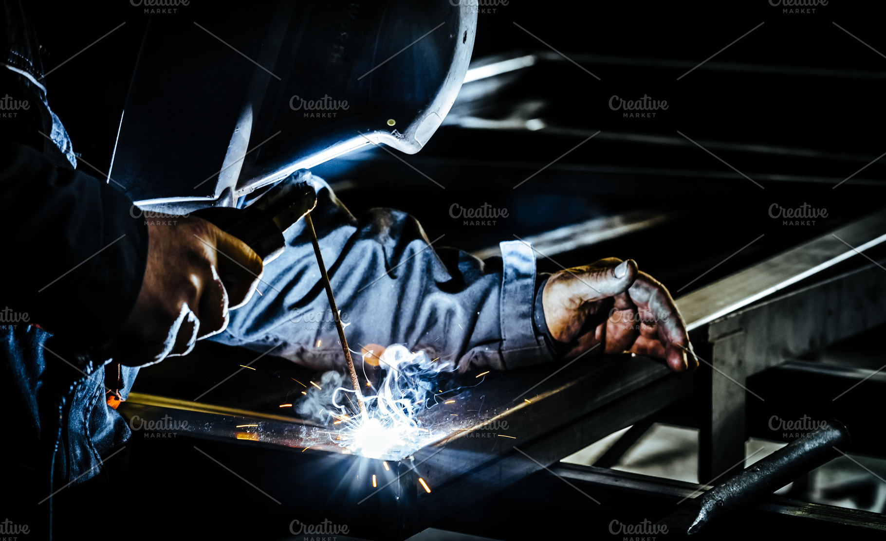 Professional man working on metal featuring welder, welding, and worker, an Industrial Photo by Shootdiem