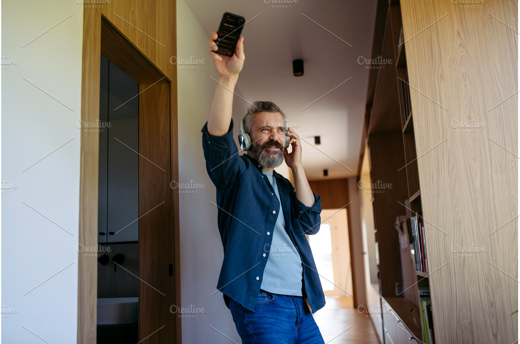 Bearded man dancing at home while, a Person Photo by HalfPoint