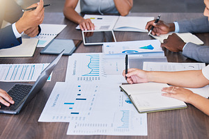 Sales, budget and finance business people, manager or accountants in meeting planning, analyzing and discussing paper work, charts and graphs data. An accounting company working on commerce analysis, a Photo by Peopleimages.com