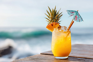 Refreshing tropical cocktail by the beach with pineapple garnish and colorful u, a Food & Drink Photo by AlyaAnd