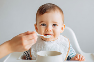Happy baby enjoying mealtime in high chair, a Person Photo by AlyaAnd