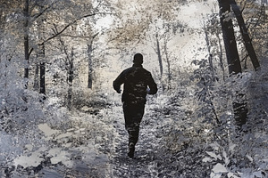 Man runs swiftly through a wooded ar, a Photo by Iftikhar Alam