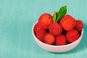 bowl with some spiky Arbutus unedo berries, a Photo by Nito