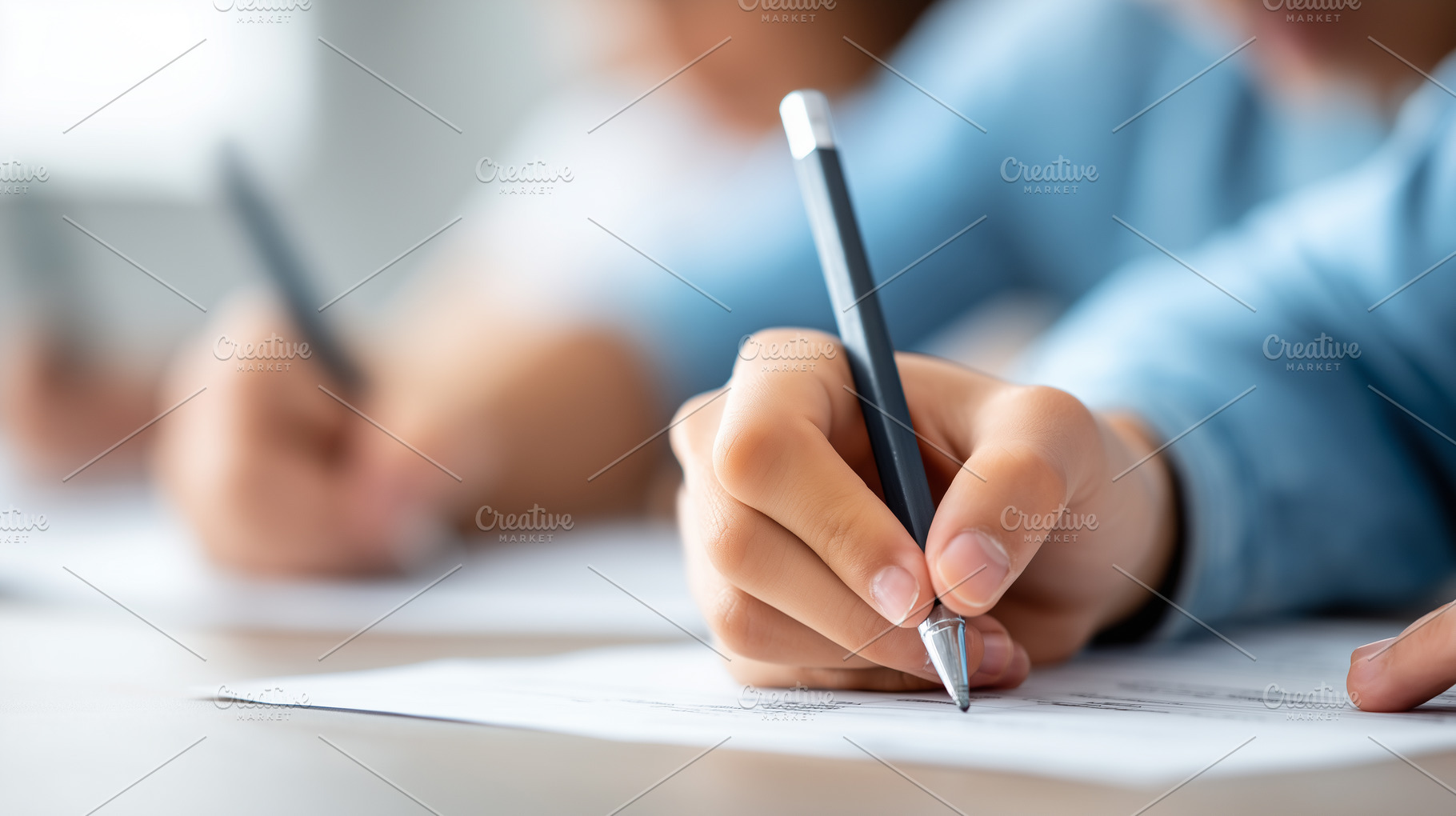 Close up of a student writing with, a School & Education Photo by MistyDay