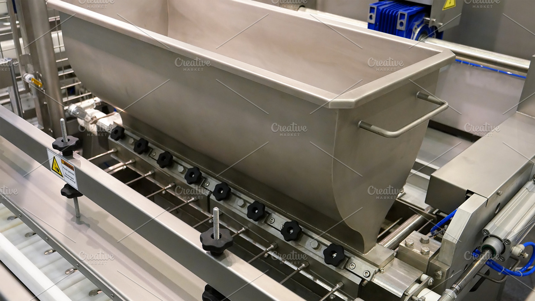 Food factory automated robotic production line featuring conveyor, product, an Industrial Photo by HighRes Pictures